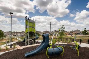 a playground with a slide in a park at Home Sweet Home -San Antonio in San Antonio