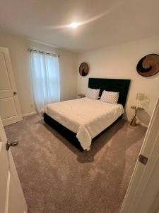 a bedroom with a bed with white sheets and pillows at Home Sweet Home -San Antonio in San Antonio