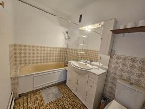 a bathroom with a tub and a sink and a bath tub at Grand appartement 160m2 equipped for professionnal groups in Sarcelles +30 photos