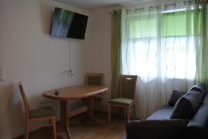 a living room with a table and a couch at Appartement Heidi in Schladming