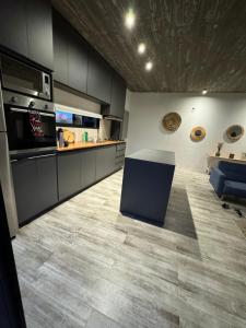 a kitchen with black cabinets and a counter top at Balneario Buenos Aires in Balneario Buenos Aires