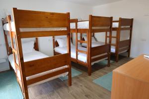 a group of bunk beds in a room at Da Serra guesthouse in Porto de Mós +40 photos