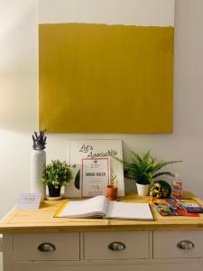 a desk with books and potted plants on it at Private room with private bathroom and backyard in Brooklyn