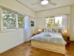 a bedroom with a bed and two windows at Shiny Blue Apartment in Limassol