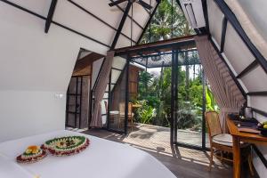 a room with a table with a plate of food on it at IPIAN Angel by Pramana Villas in Ubud