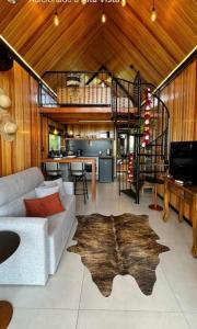 a living room with a white couch and a wooden ceiling at Alta Vista Cabanas in Garibaldi