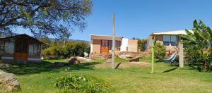 a house with a hammock in front of a yard at CABAÑA LOS JUANES in Sutamarchán +13 photos