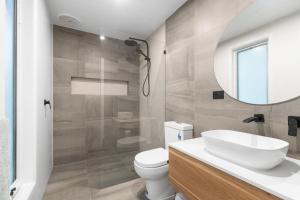a bathroom with a toilet and a sink and a mirror at Secluded Seaside Hideaway in Rye +9 photos