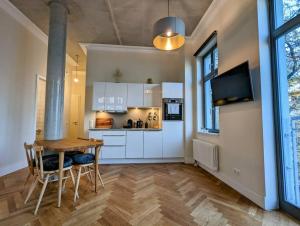 a kitchen and dining room with a table and chairs at Modern building with vertical garden & 2 bedrooms in Berlin