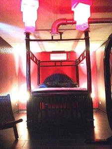 a bed in a room with a red wall at VIP Design Apartment m. Dachterrasse in Dresden