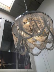 a wicker chandelier hanging from a ceiling at VIP Design Apartment m. Dachterrasse in Dresden