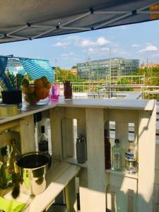 a table with a bowl of fruit on a balcony at VIP Design Apartment m. Dachterrasse in Dresden