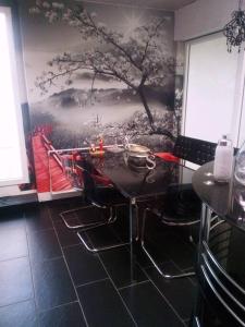 a kitchen with a tree mural on the wall at VIP Design Apartment m. Dachterrasse in Dresden