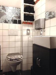 a bathroom with a toilet and a sink at VIP Design Apartment m. Dachterrasse in Dresden