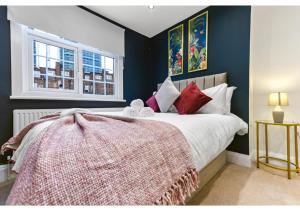 a bedroom with a large bed and a window at Homey and Pleasant 3BD in London