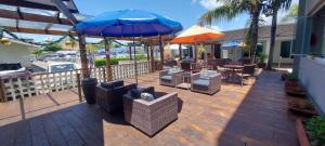 a patio with tables and chairs and umbrellas at Hotel Santa Paula in Guaratuba