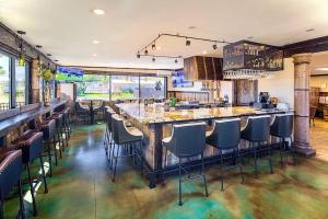 a bar with chairs and a long counter in a room at Luxury Downtown Moab Rental - La Dolce Vita Villa #1 in Moab
