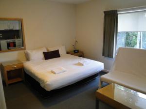 a hotel room with a bed and a window at Brighton Serviced Apartments in Melbourne