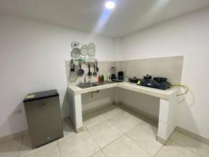 a kitchen with a sink and a counter with utensils at Apto en cucuta trapiches cerca a la Toyota in Villa del Rosario