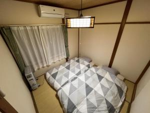 Rúm í herbergi á Nagayama Home