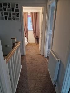 a hallway with a stairway leading to a room at Well Furnished 3 Bedroom House in a cosy estate in Bolton in Bolton