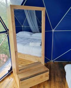 a small room with a bed in a tent at Villas del Rio Glamping in San Francisco