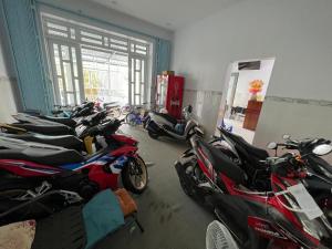 Una fila de motocicletas estacionadas en una habitación en Nhà Nghĩ Cao Thắng en Bạc Liêu
