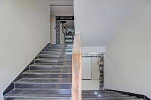 a staircase in a building with a metal railing at Collection O Hotel Raj Mahal in Turambhe