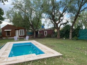 a swimming pool in the yard of a house at Cabaña Terra Calma in Vistalba