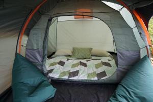 an open tent with a bed in it at ZOYA HILLS in Pondok Cipaseban