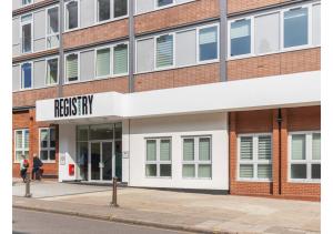 a brick building with a sign that reads professionals inn at Designer Flat in Prime Location in Beckenham