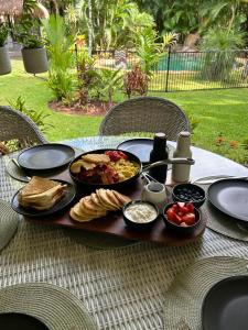 a table with a tray of breakfast food on it at Paperbark Retreat in Cooktown