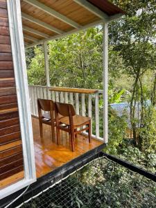 a wooden bench sitting on a porch of a house at Villas del Rio Glamping in San Francisco