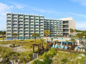 a large building with a pool and a resort at Top of the Gulf 523 - Beach Front Resort With Ocean View in Panama City Beach