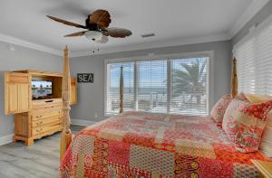 a bedroom with a bed and a ceiling fan at 910 Ocean Boulevard in Isle of Palms