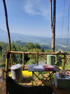 a table on a balcony with a view at ZOYA HILLS in Pondok Cipaseban