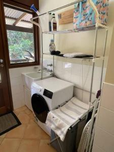 a hospital room with a machine and a sink at Heartwood Hill in Uki