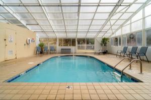 a swimming pool with a ceiling and chairs in a building at Condo in Gatlinburg very peaceful - 10 min Walk to Main Strip in Gatlinburg