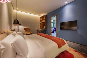 TV a/nebo společenská místnost v ubytování Nanxianglou Art Hotel