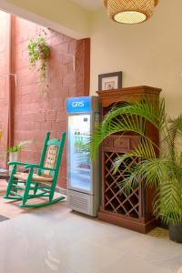 a blue gas pump next to a green chair at Hotel D'Cornelio in Santo Domingo