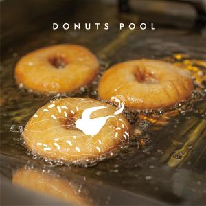 two donuts are cooking in an oven with a pretzel at CAFE/MINIMAL HOTEL OUR OUR in Tokyo