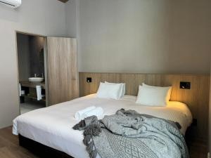 a bedroom with a bed with a blanket on it at Chalet Infinity by The Hakuba Collection in Hakuba