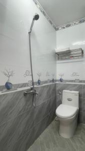 a bathroom with a toilet and a shower at ALEX HOTEL in Ho Chi Minh City