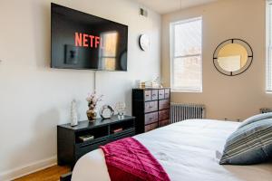1 dormitorio con 1 cama y TV en la pared en 2 Bedrooms at the heart of the City! Full Comfort!, en Washington