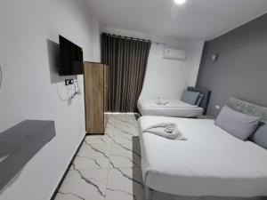 a room with a bed and a tv and a couch at NADA Hostel in Cairo