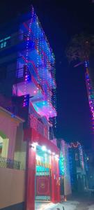 a building with christmas lights on the side of it at Hotel Atithi Satkar , Gobarsahi in Muzaffarpur