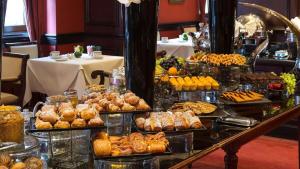 a buffet with many different types of pastries and desserts at Relaxing Stay at Executive Hotel San Francisco in San Francisco