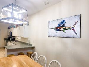 a kitchen with a table and a painting on the wall at Endless Summer Beach House in Myrtle Beach