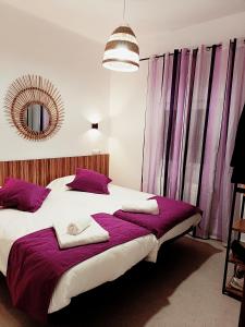 a bedroom with a large bed with purple curtains at Violeta Suite in Madrid