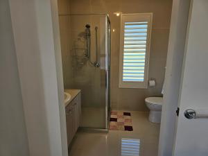 a bathroom with a shower and a toilet at Timeless Safaris in Botanic Ridge +6 photos